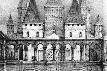 A historic photograph of the entrance to the Abbey of Cluny, France