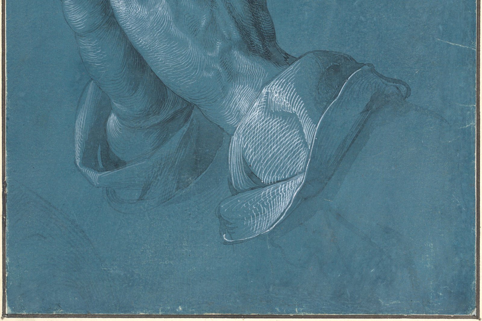 Albrecht Dürer's ink and chalk drawing of two clasped hands raised in prayer, fingers pointing upward