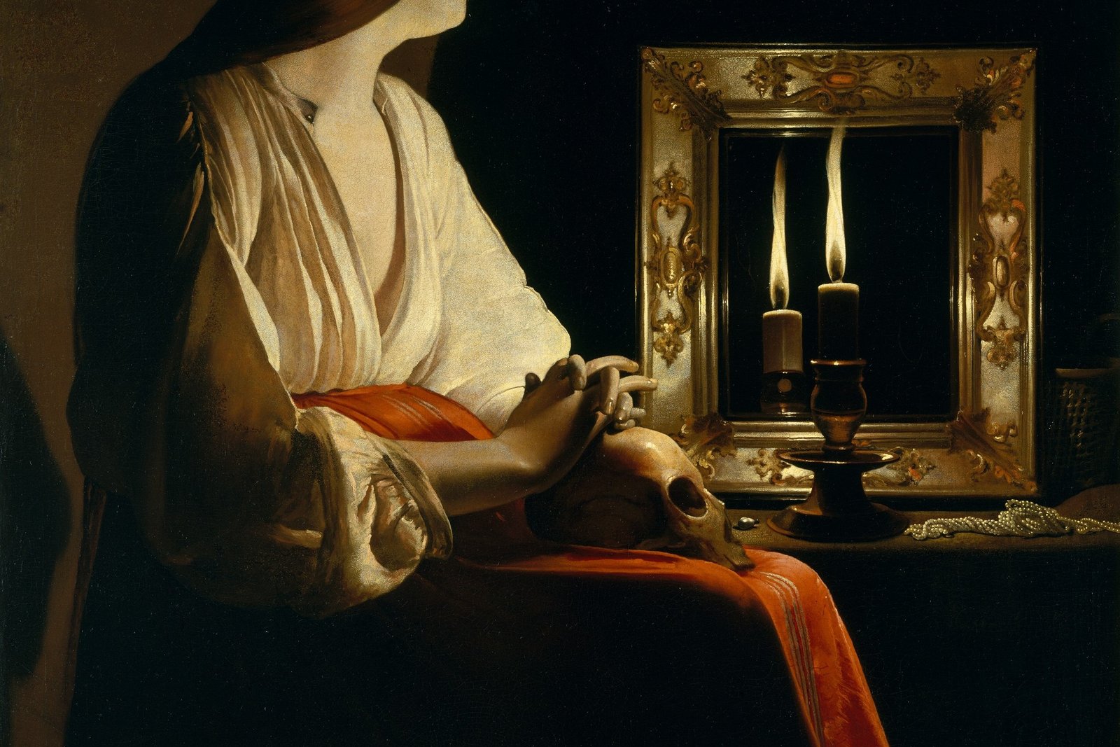 A candlelit painting of Mary Magdalene seated in darkness, one hand resting on a skull in her lap, gazing at the candle flame