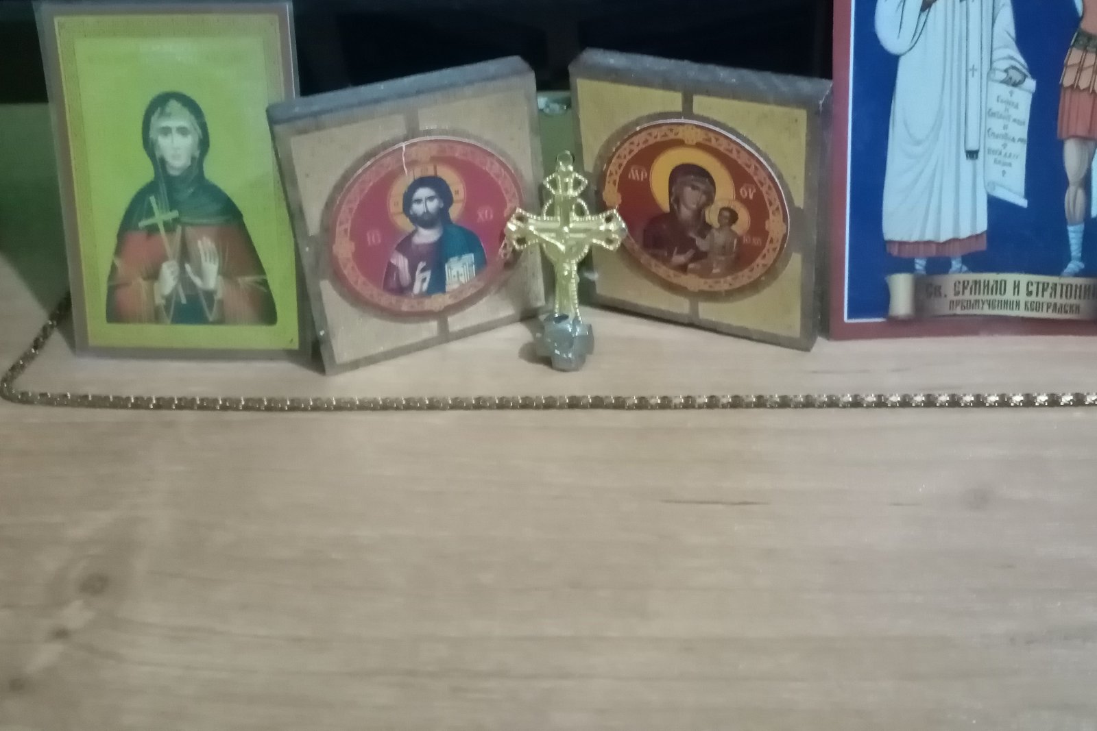 A small home prayer corner with devotional icons of Christ, the Virgin Mary, and saints, alongside a crucifix.