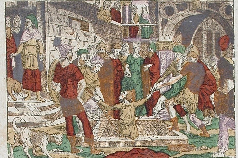 Hand-colored 16th-century woodcut showing Jeremiah being pulled up from a cistern by ropes as soldiers and officials look on, illustrating Jeremiah 38.