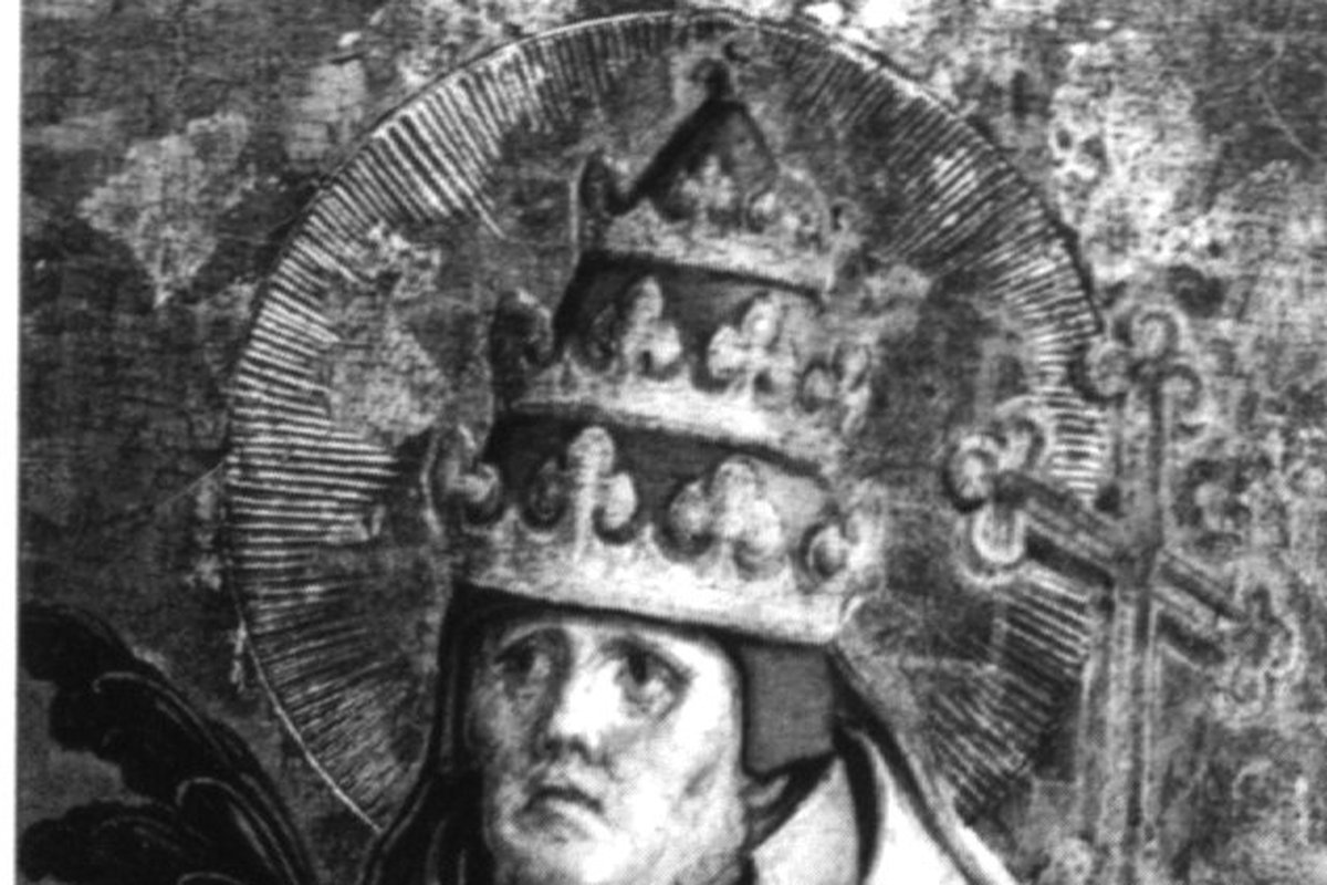 A bearded pope wearing a jeweled triple crown and golden halo, holding an open book and a processional cross, in a weathered Renaissance-era panel painting.