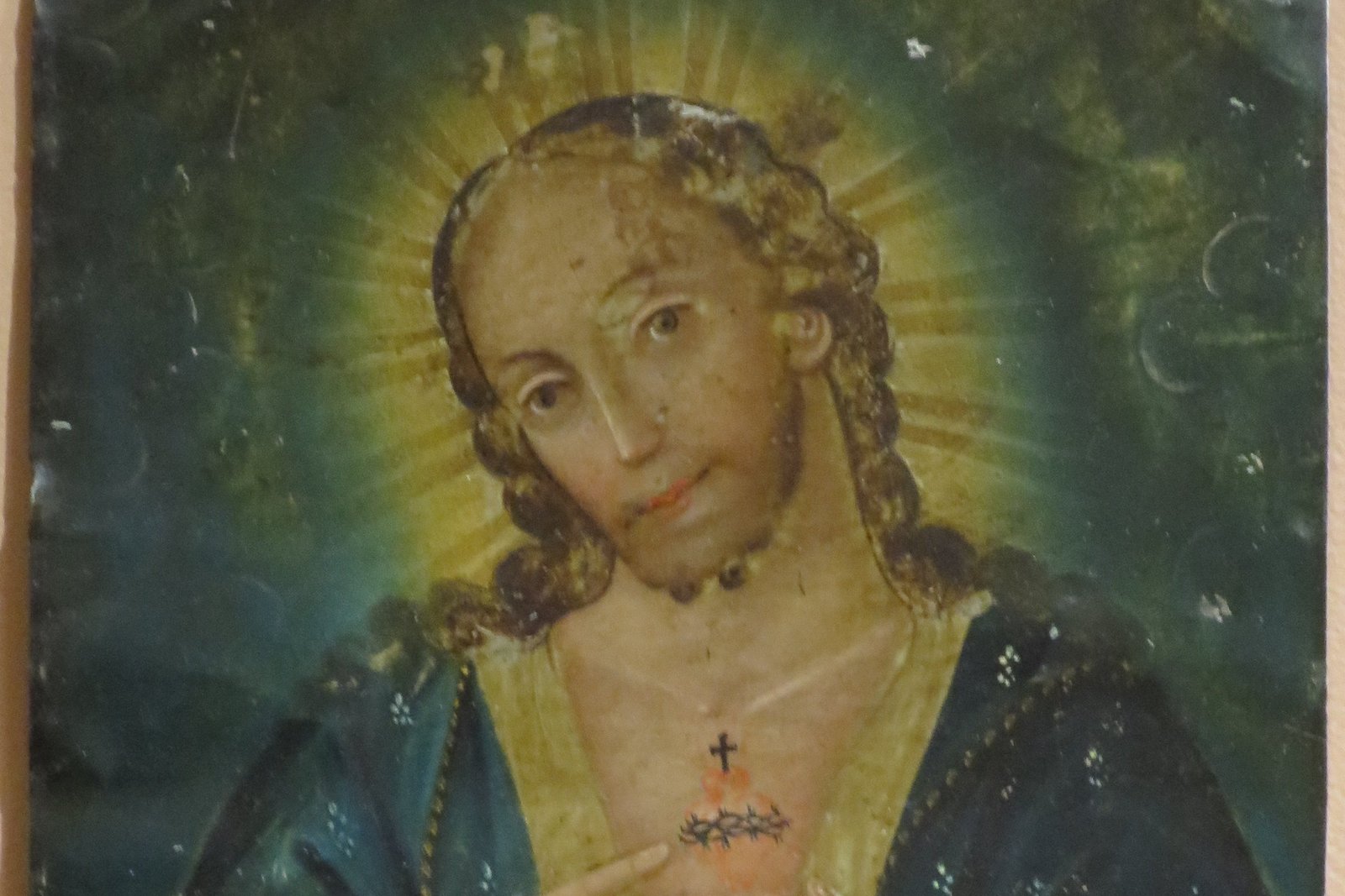 An anonymous 19th-century Mexican devotional retablo painting on tin, showing Christ's chest opened to reveal a flaming heart wrapped in thorns.