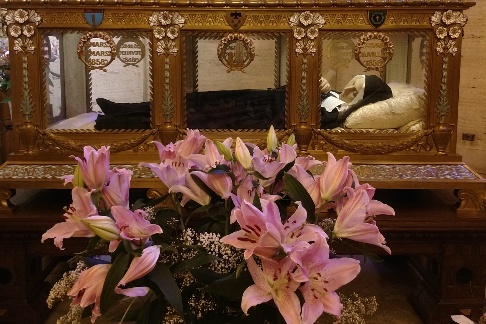 The glass and gilded reliquary at the Convent of Saint-Gildard in Nevers, France, containing the preserved body of Saint Bernadette Soubirous