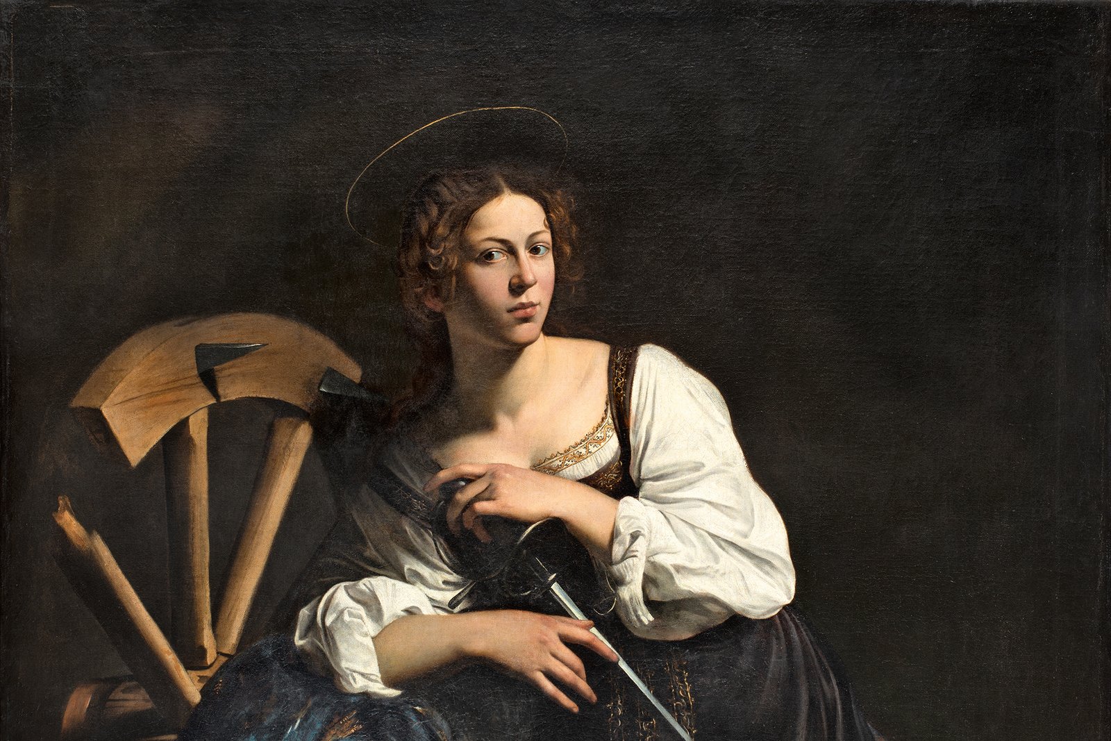 A Baroque painting of Saint Catherine of Alexandria leaning against the breaking wheel of her martyrdom.
