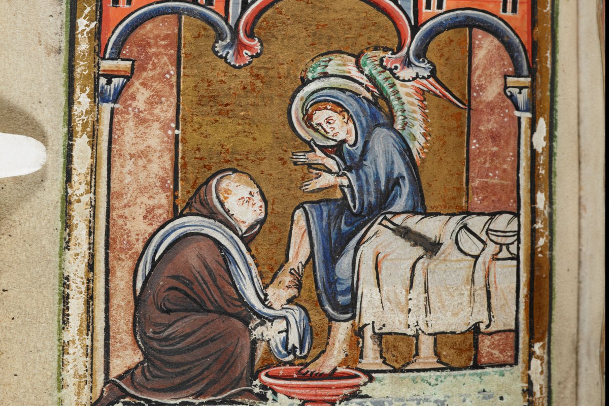 A medieval illuminated manuscript miniature showing a kneeling monk washing the feet of a haloed, hooded figure seated beneath an arched building, from a 12th-century copy of Bede's Life of Saint Cuthbert.
