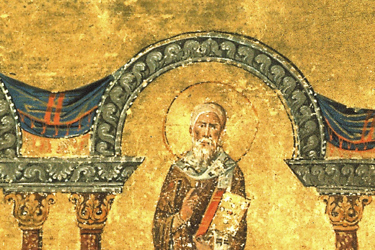 A Byzantine icon of two robed, haloed bishops standing beneath ornate golden arches, each holding a jeweled book, from an 11th-century illuminated manuscript.
