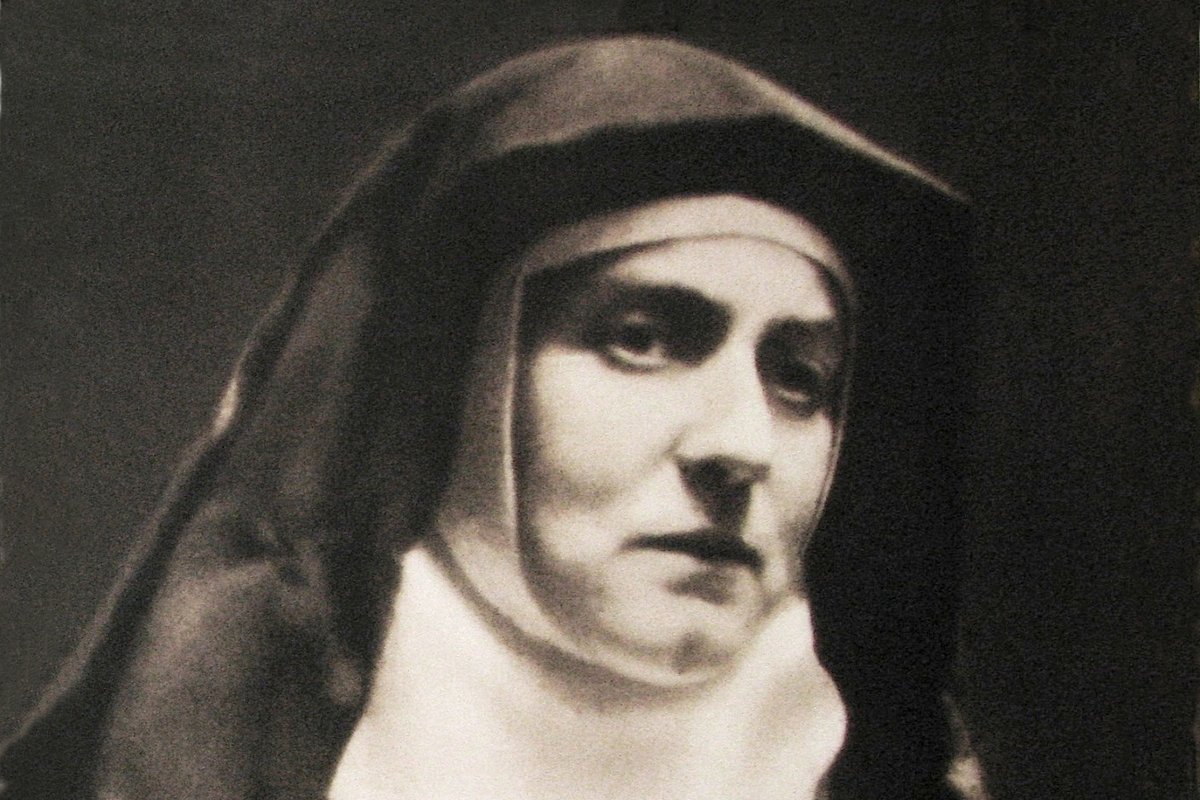 A black-and-white photograph of Edith Stein in Carmelite habit and veil, taken at the Cologne Carmel around 1938.