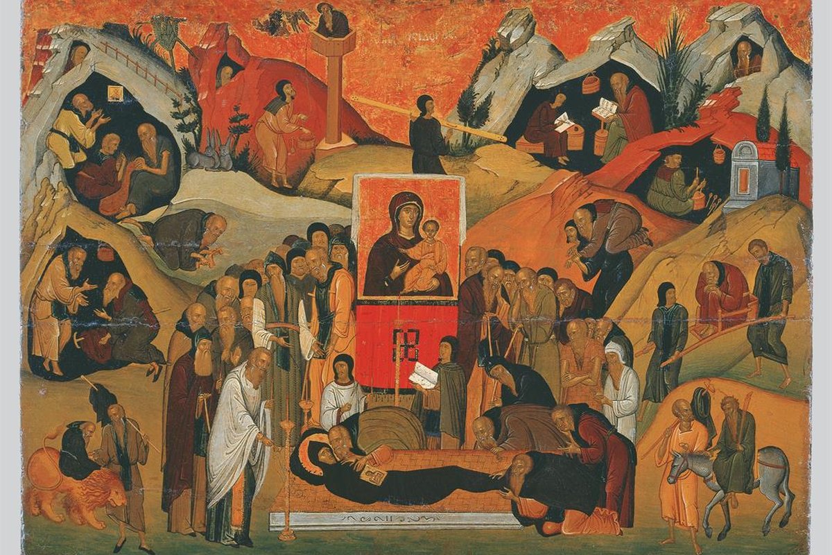 A 15th-century Cretan icon depicting the death of Saint Ephrem the Syrian, surrounded by monks in a mountainous, cave-dotted landscape with an icon of the Virgin and Child carried at the center.