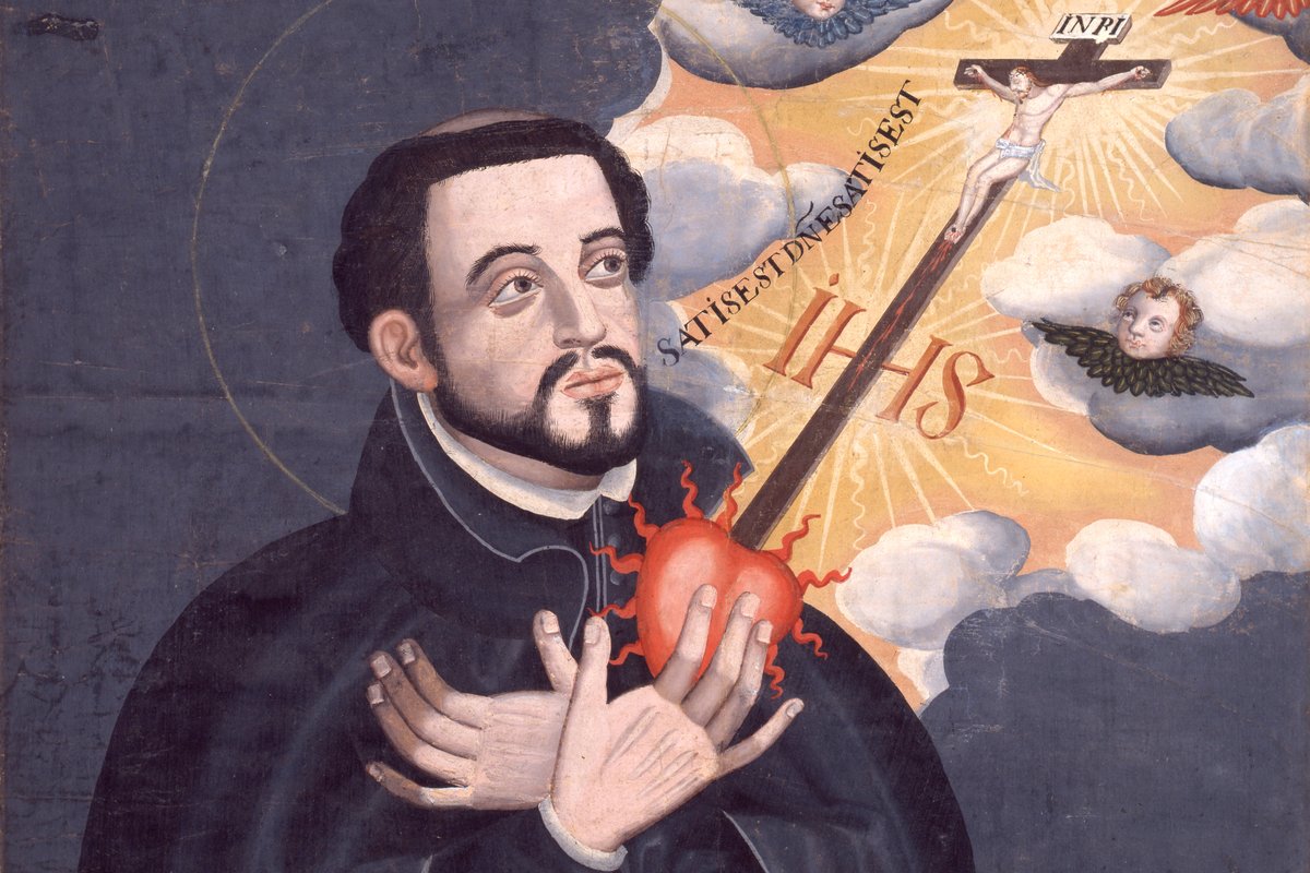 A Japanese Kirishitan-era painting of Saint Francis Xavier in a black cassock, gazing upward with his hands pressed to a flaming heart, beneath a vision of the crucified Christ surrounded by cherubs.