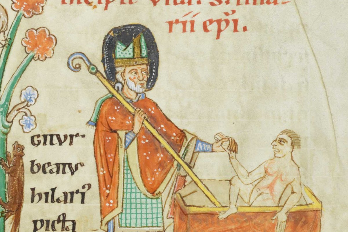 A medieval illuminated manuscript miniature of a bearded bishop saint in a mitre and orange cope, holding a crozier and reaching out to a man seated in a chest-like tomb.