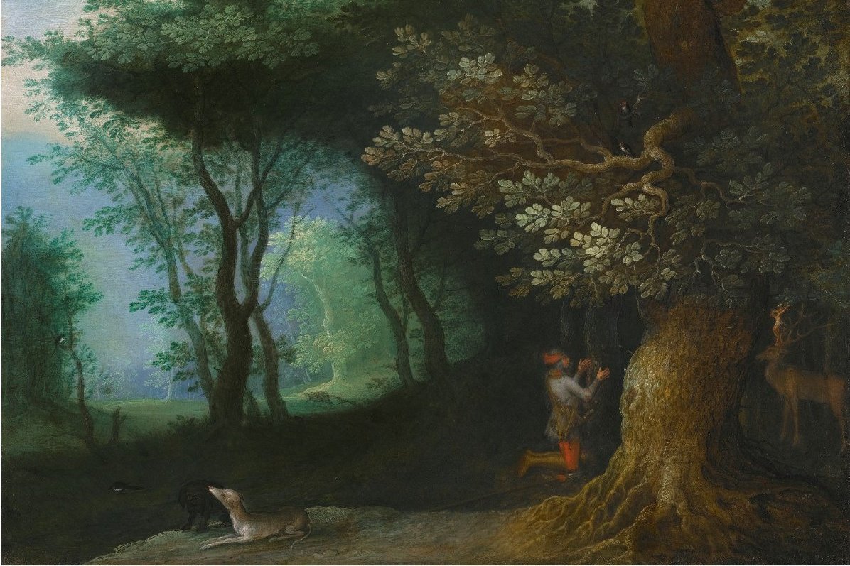 A 17th-century oil painting of a dense forest with a kneeling hunter in red hose praying before a great oak tree, his hounds resting nearby and a stag visible in the shadows to the right.