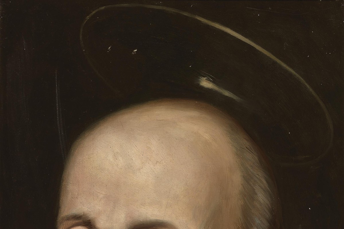 A dark, solemn portrait of Saint Ignatius of Loyola with a faint halo, wearing plain black clerical dress.