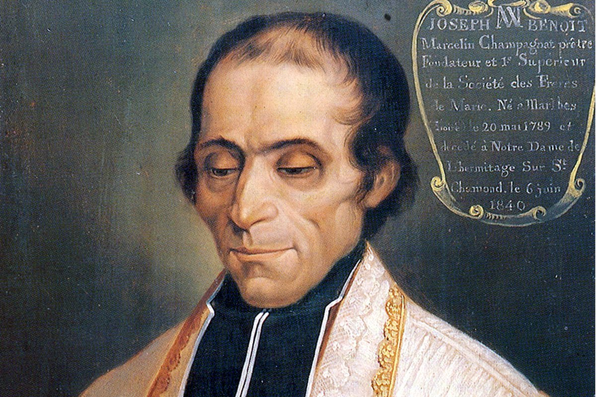 A close devotional portrait of Father Marcellin Champagnat in white and gold vestments, looking downward with a gentle expression, beside a gold inscription cartouche.