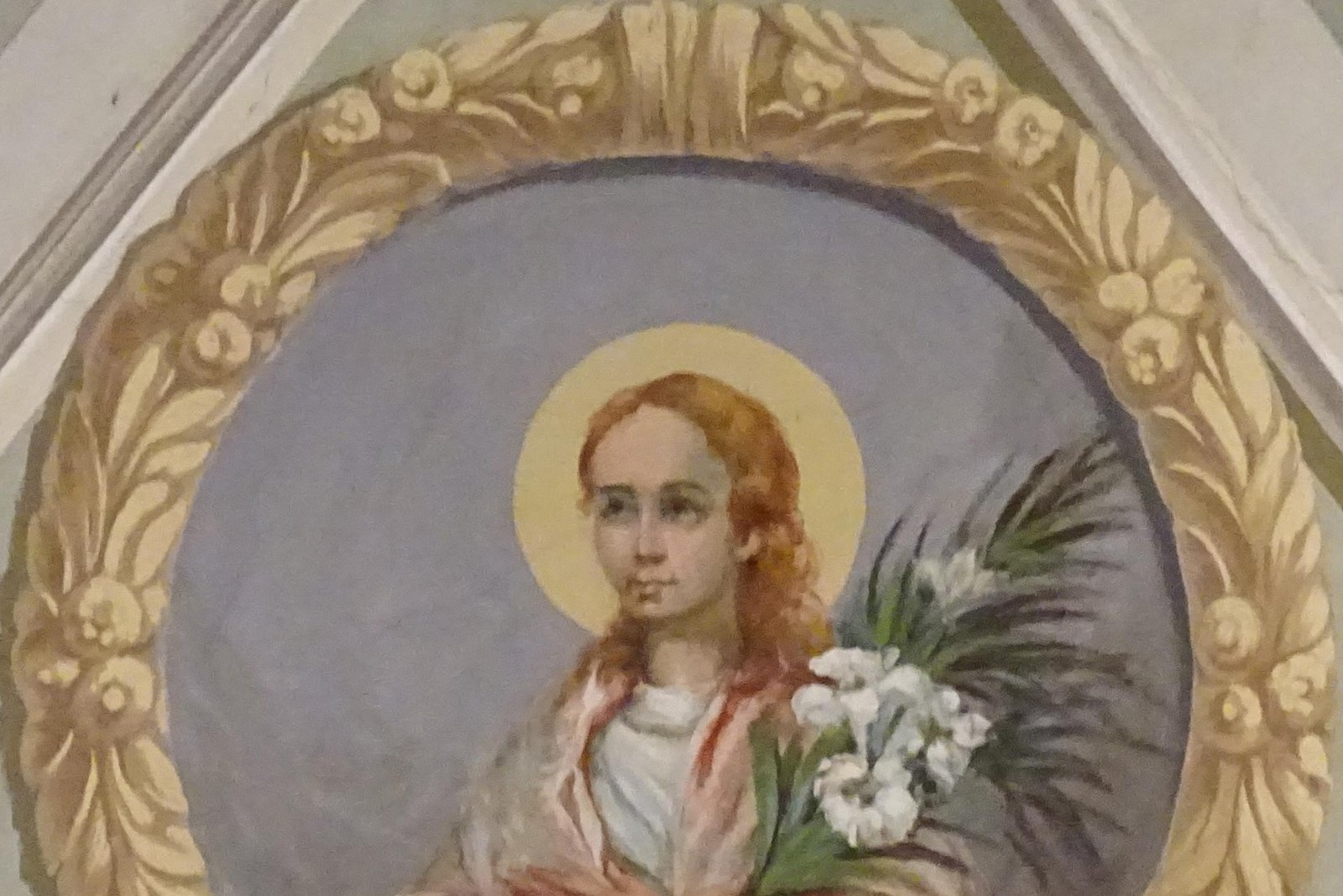 Devotional fresco medallion of Saint Maria Goretti, a young girl with a golden halo, holding a martyr's palm branch and white lilies