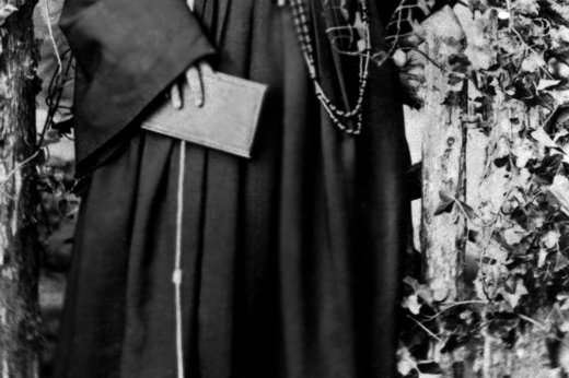 A black-and-white 19th-century photograph of a young woman in a Franciscan nun's habit and veil, seated formally for a portrait.