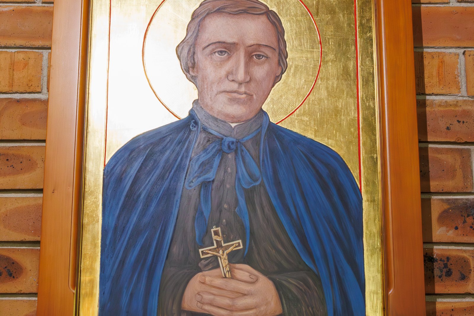 Gold-ground icon of Saint Peter Chanel, haloed, holding a crucifix, labeled 'St Peter Chanel'