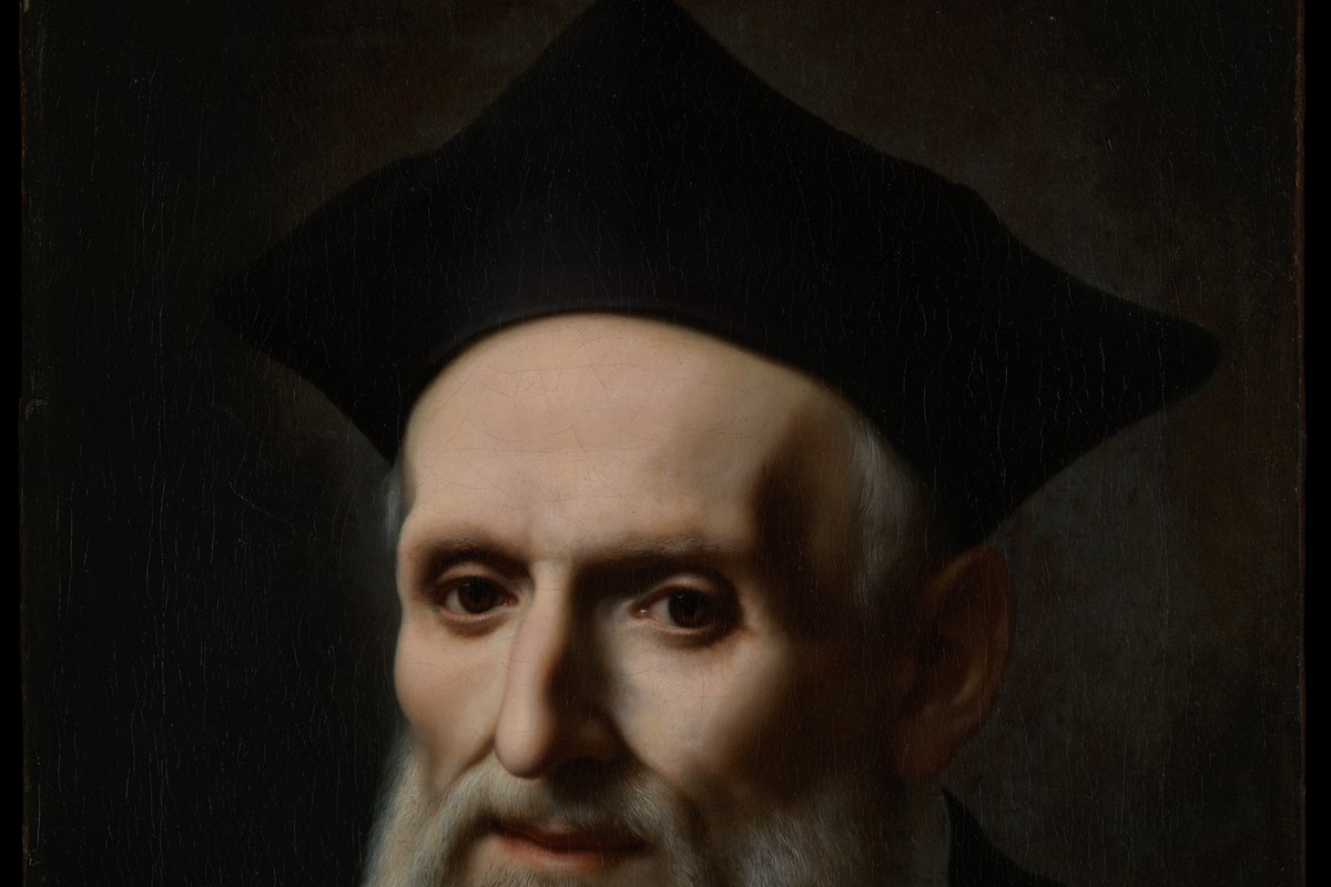 A portrait of a Renaissance-era Catholic priest with a warm, animated expression, dressed in dark clerical robes.