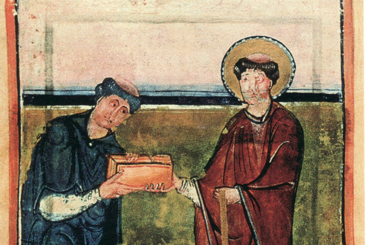 A medieval illuminated manuscript miniature showing a monk in blue presenting a book-shaped reliquary casket to a haloed bishop in red vestments holding a staff.