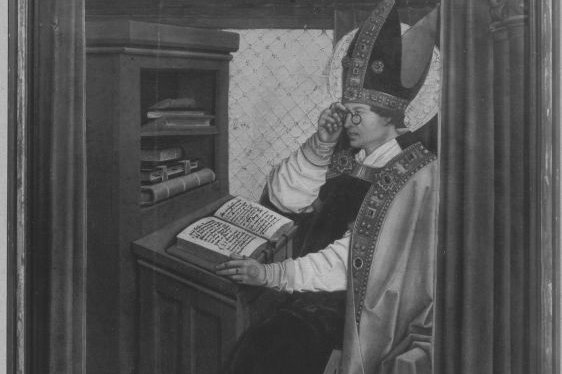A tempera altarpiece panel showing Saint Servatius as a bishop in full vestments and mitre, seated at a writing desk with an open illuminated book.
