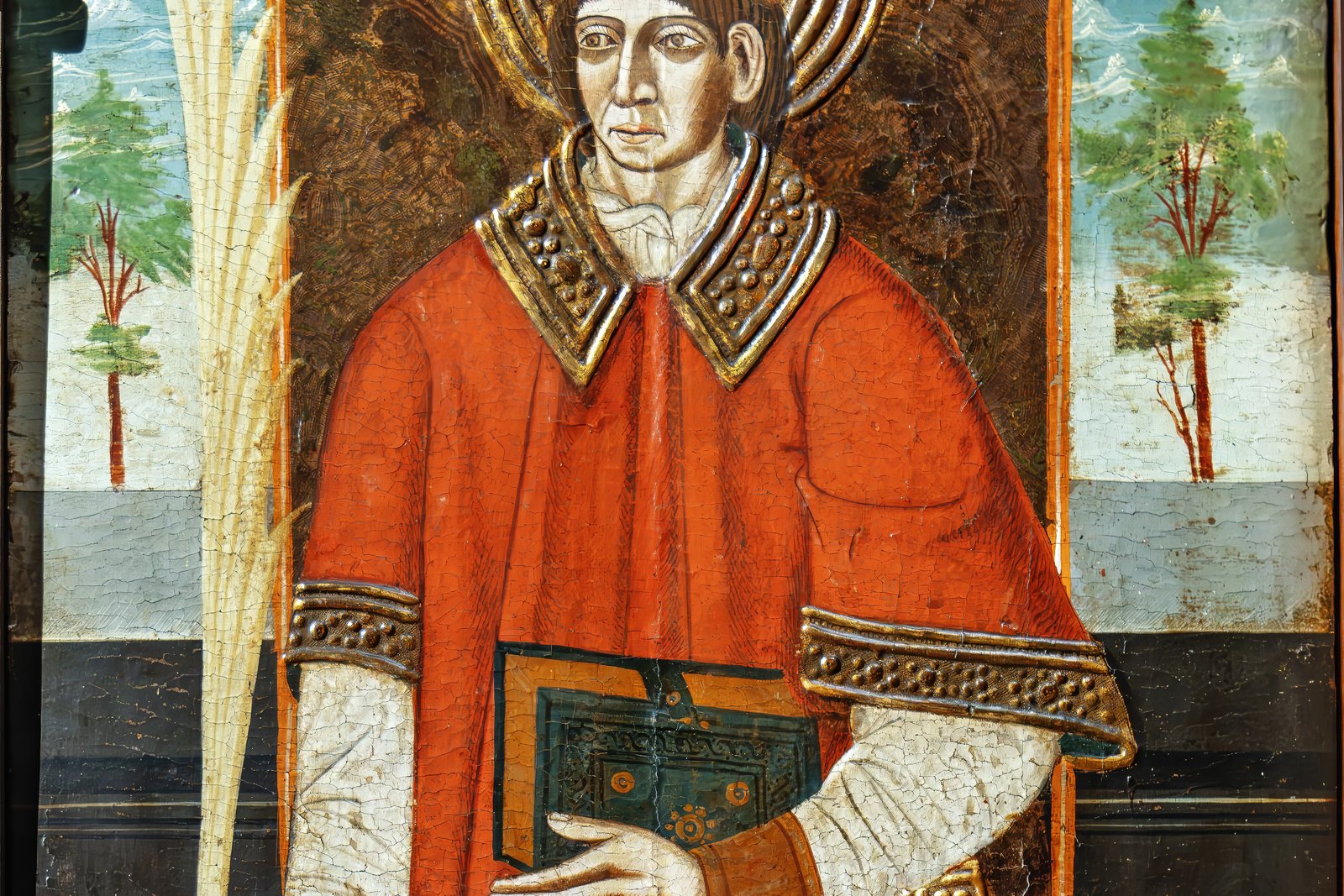 A Gothic panel painting of Saint Vincent of Saragossa as a young deacon in red vestments, holding a book and a palm branch of martyrdom.