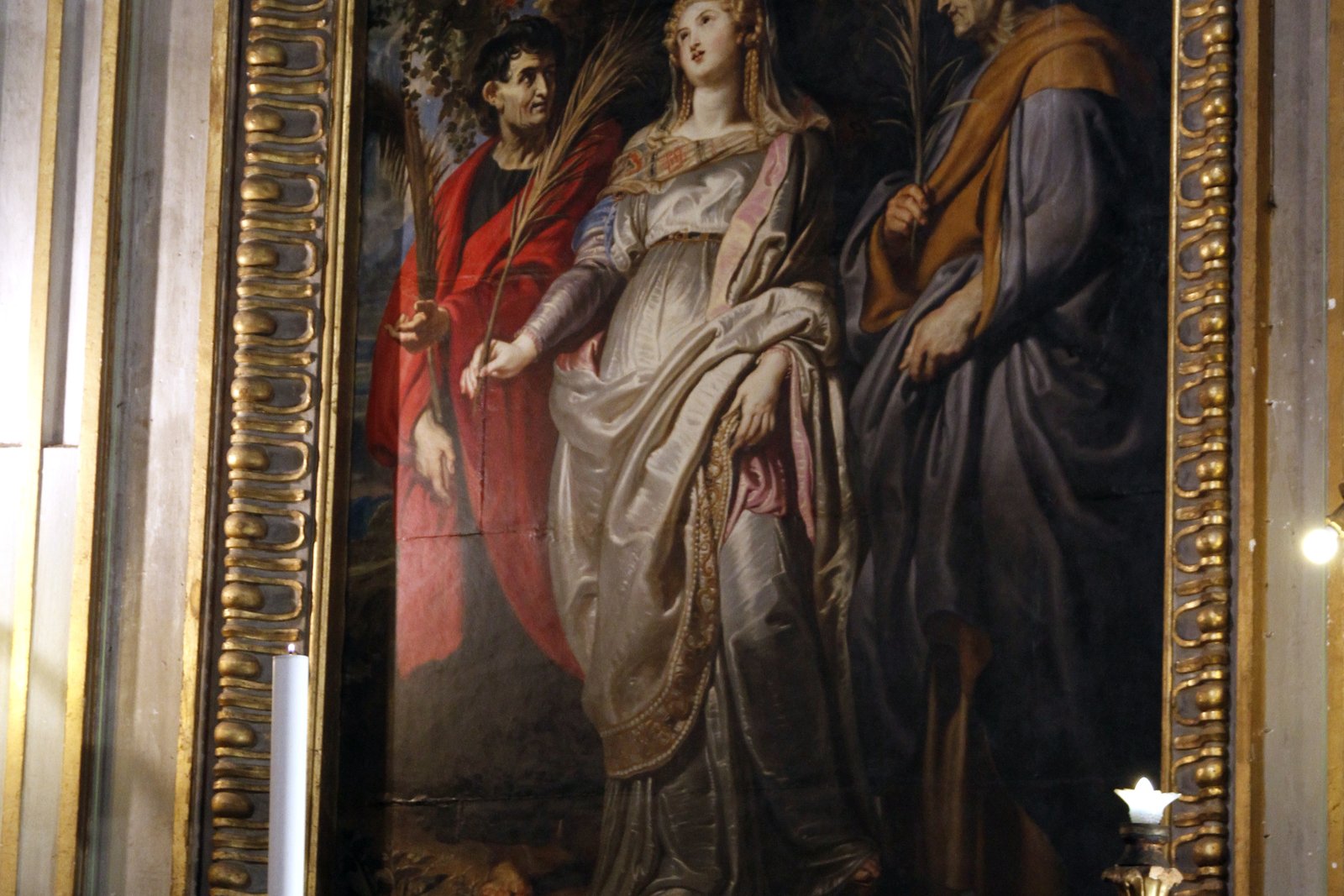 A Baroque altarpiece painting of Saint Nereus and Saint Achilleus standing beside Saint Flavia Domitilla, all in rich robes and holding martyrs' palms.
