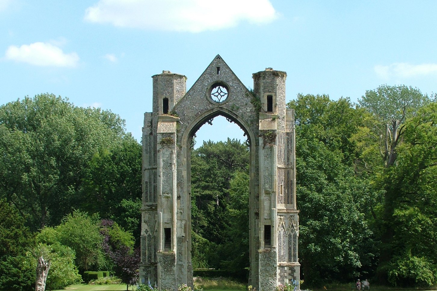The ruined stone arch of the medieval Walsingham Priory, remnant of the original shrine.