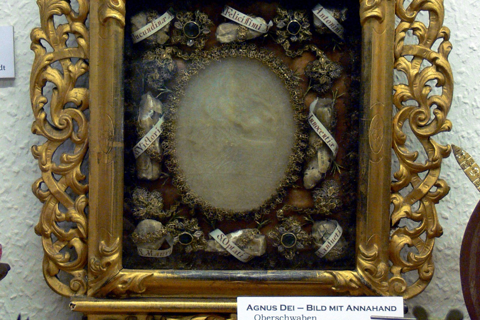 An 18th-century Agnus Dei wax relief from Oberschwaben, showing a devotional wax medallion mounted with relics and gilded wood framing, held at the Museum für Klosterkultur in Weingarten