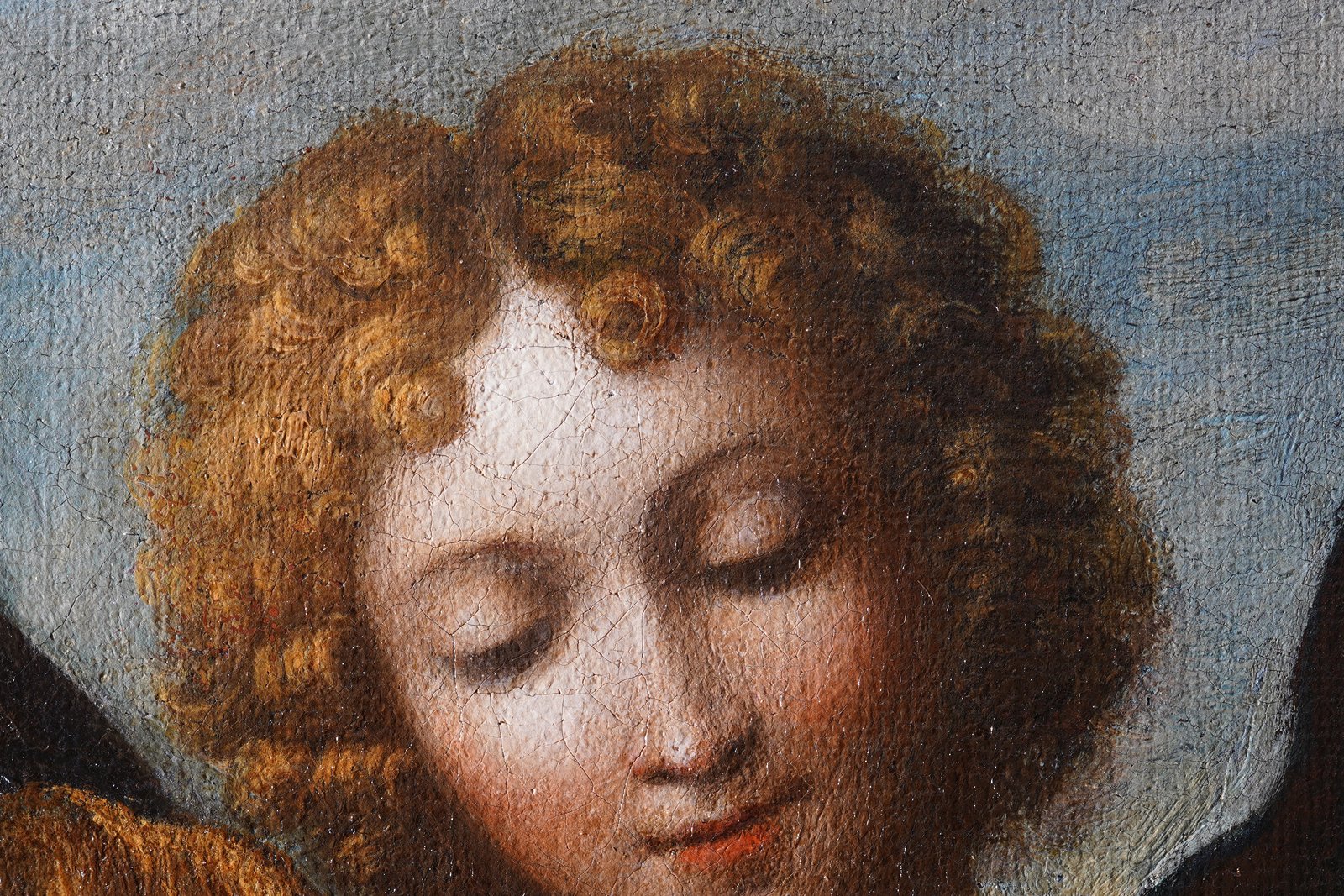 A Baroque-style painting of an angel's head, radiant and turned upward, from a 1615 depiction of the Guardian Angel.