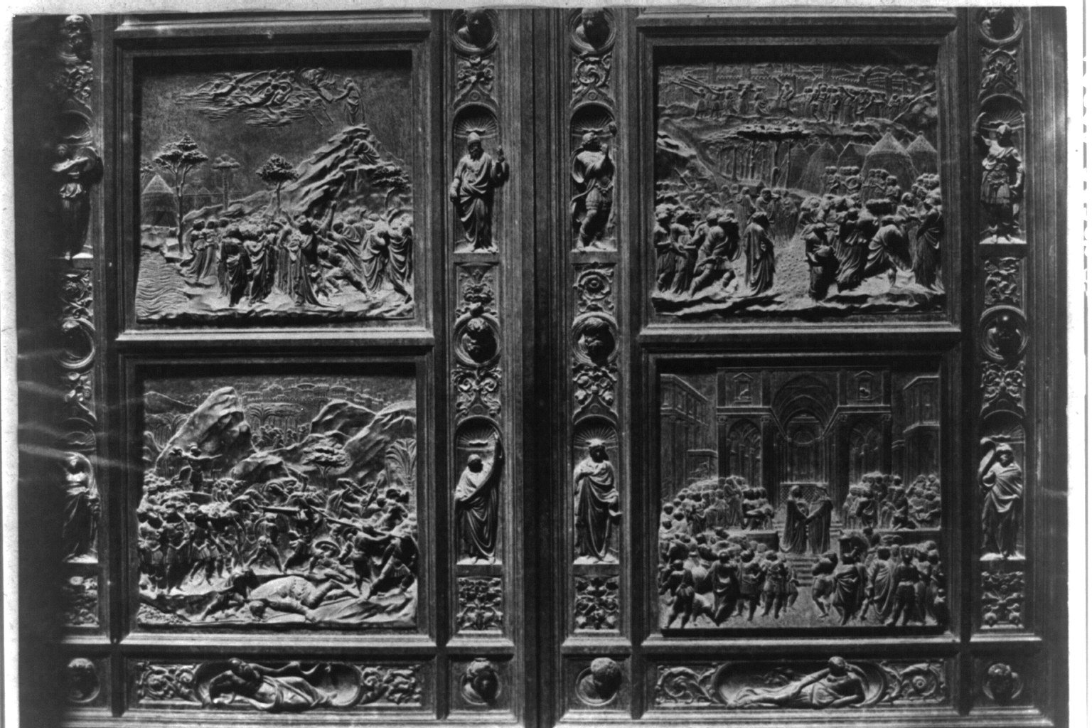The gilded bronze east doors of the Florence Baptistery, known as the Gates of Paradise, showing multiple relief panels depicting Old Testament scenes.
