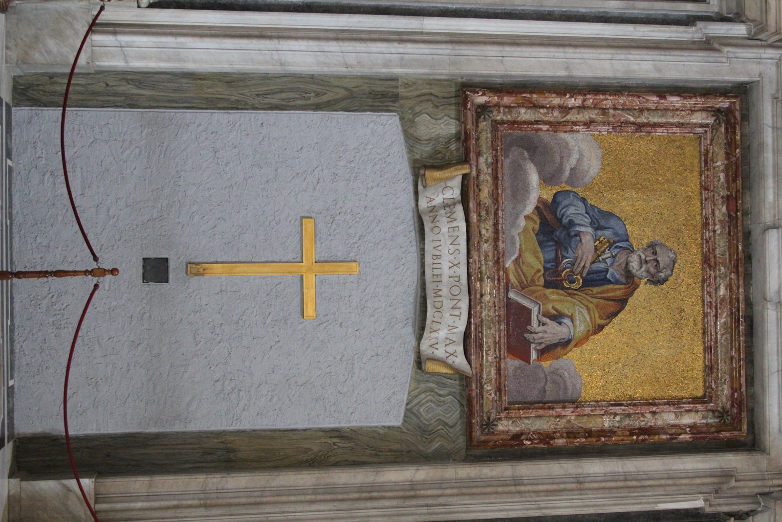 A mosaic of Saint Peter above a sealed Holy Door in St. Peter's Basilica, with a scroll inscribed with a pope's name and jubilee year.