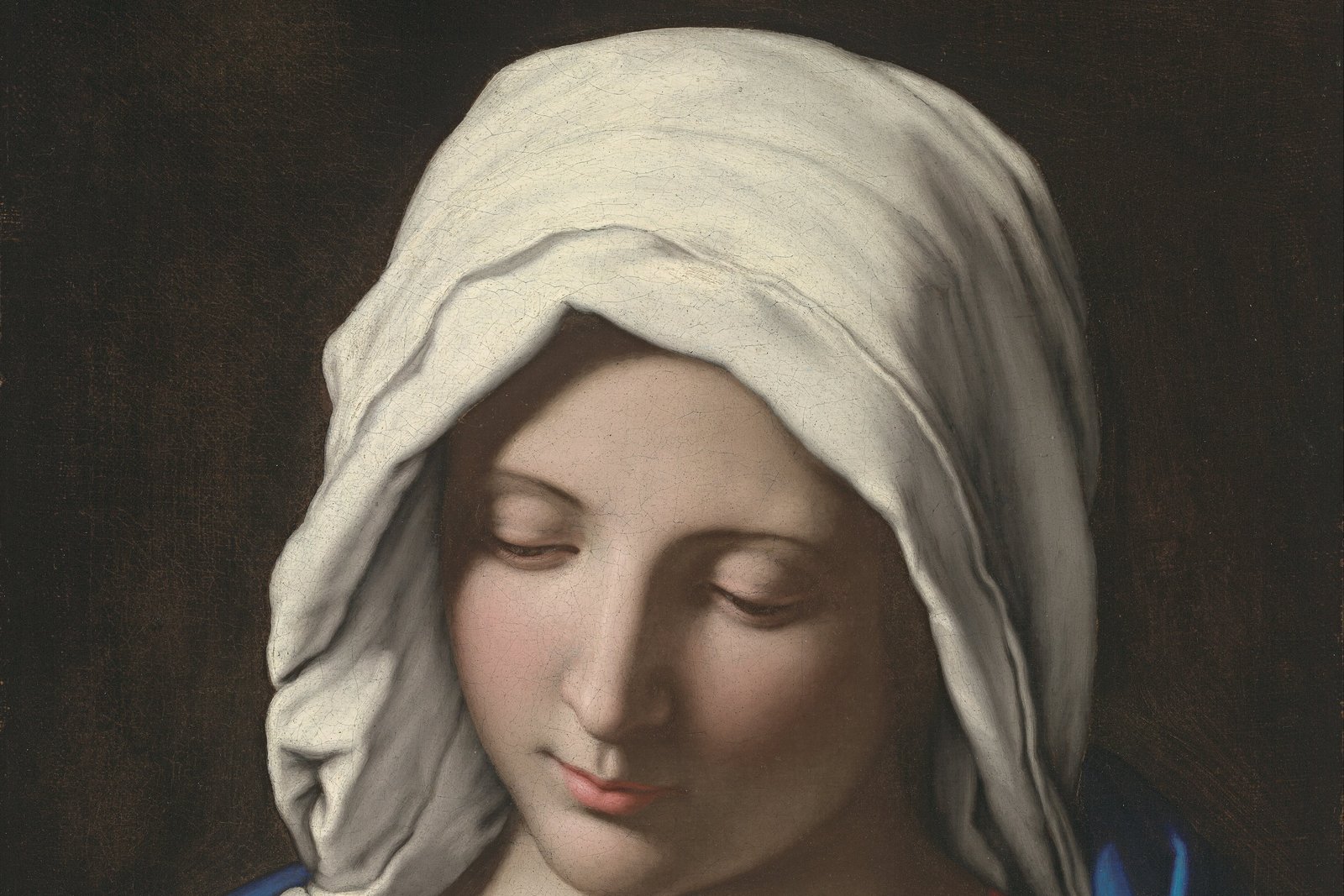 A Baroque painting of the Virgin Mary in prayer, hands folded, eyes lowered.