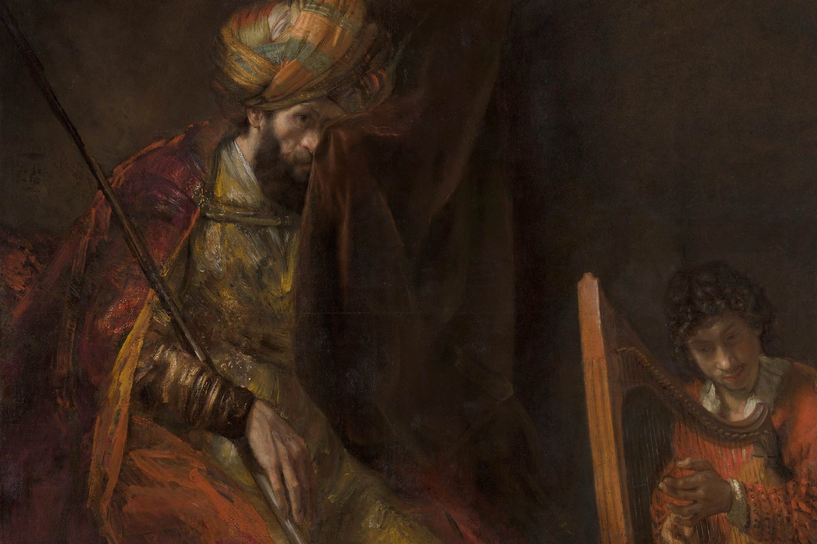 Rembrandt painting of King Saul seated and troubled, listening to the young David playing the harp to soothe him.