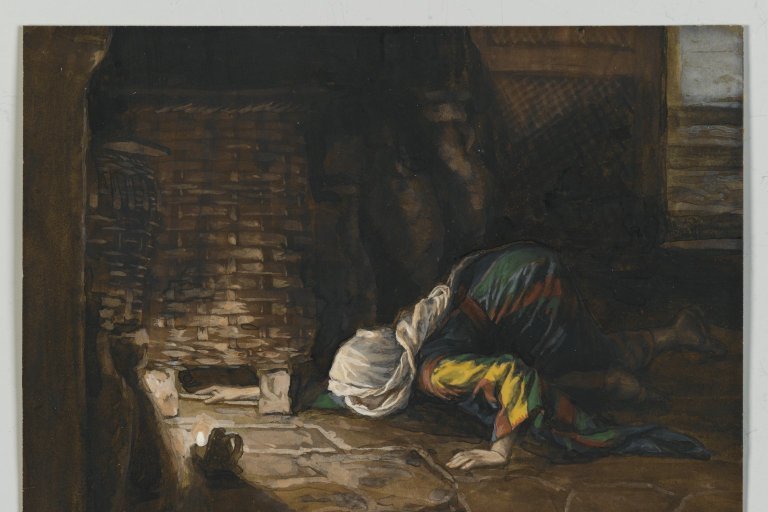 A woman kneeling by lamplight, carefully searching the floor of her home for a lost coin