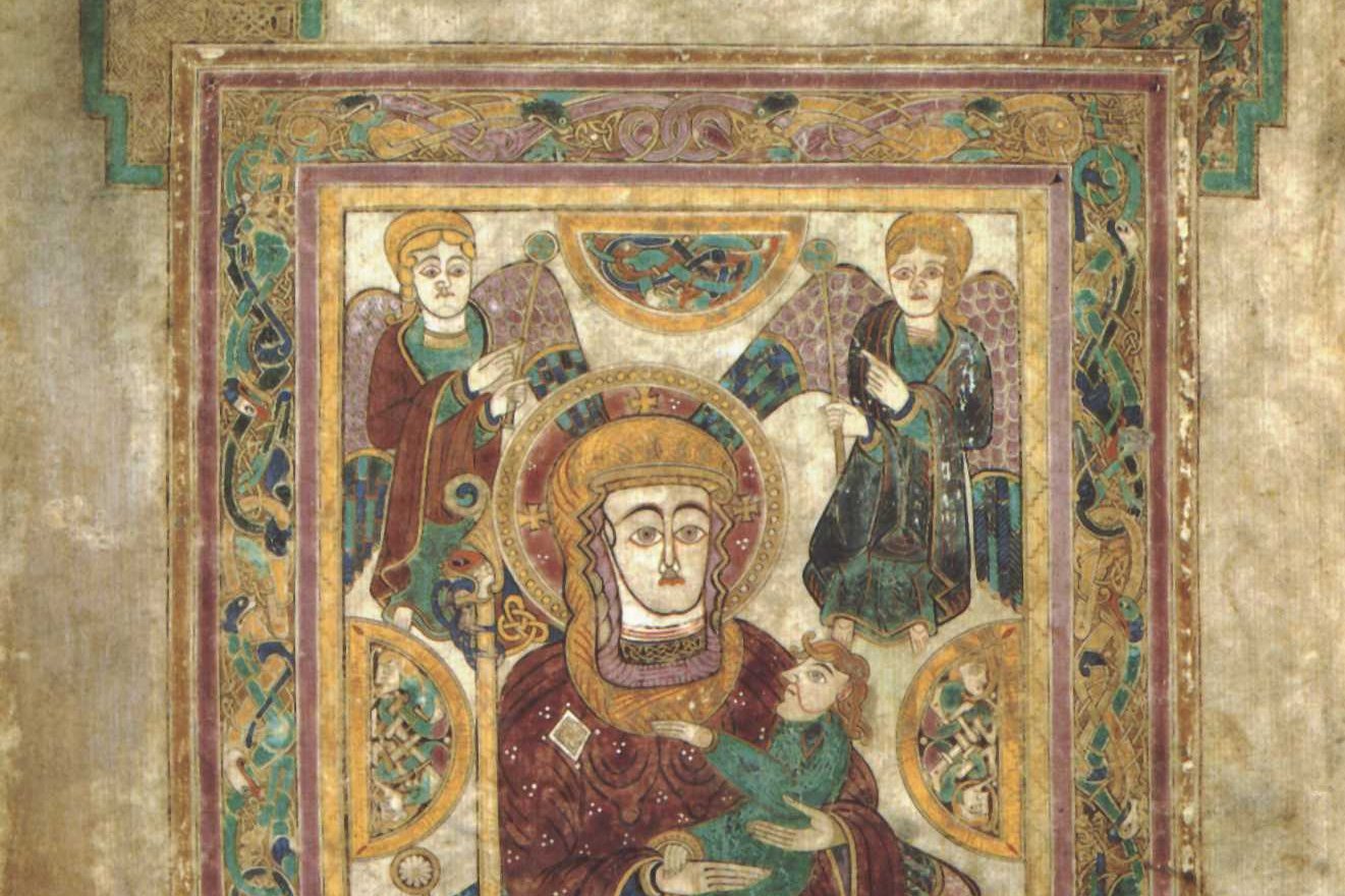 Illuminated manuscript page from the Book of Kells showing the Virgin and Child surrounded by angels, framed by interlaced corner medallions of triquetra knotwork.