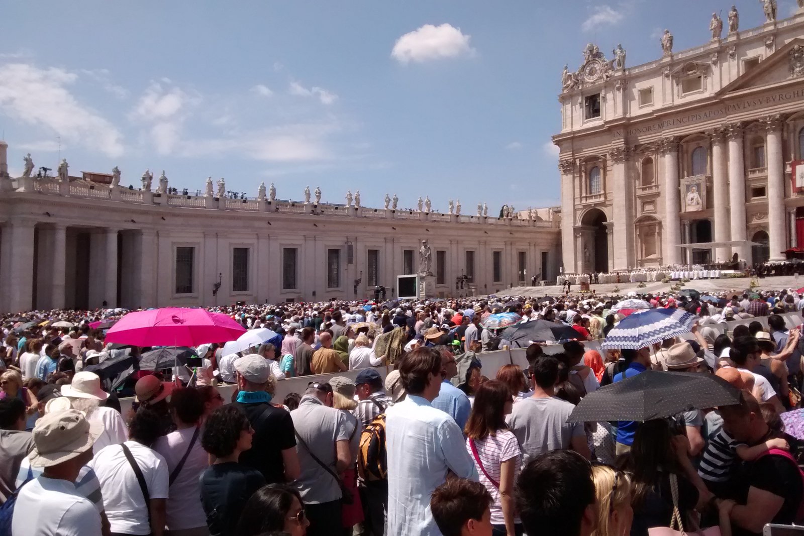 A crowd of pilgrims and tourists gathered in St. Peter's Square in Vatican City.
