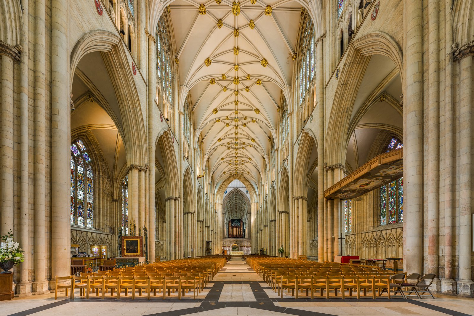 The vaulted Gothic nave of York Minster in York, England, lined with tall stone columns and pointed arches